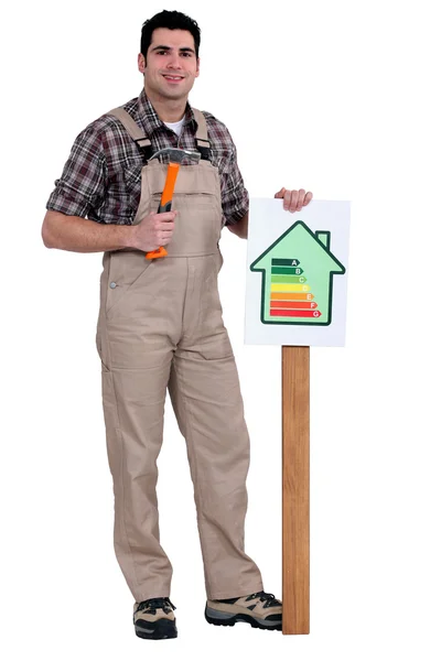 Craftsman putting an energy consumption label — Stock Photo, Image