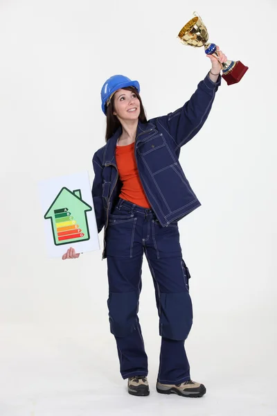 एक महिला निर्माण कार्यकर्ता एक ट्रॉफी कप पकड़े हुए . — स्टॉक फ़ोटो, इमेज