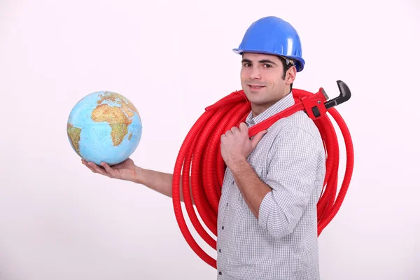 Plumber with globe in hand — Stock Photo, Image