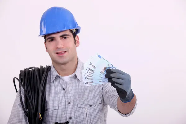 Worker holding bunch of bank notes — Stock Photo, Image