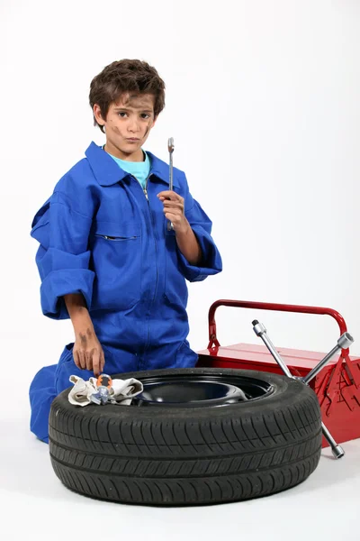 Portrait of schoolboy dressed as garage mechanic — Stock Photo, Image