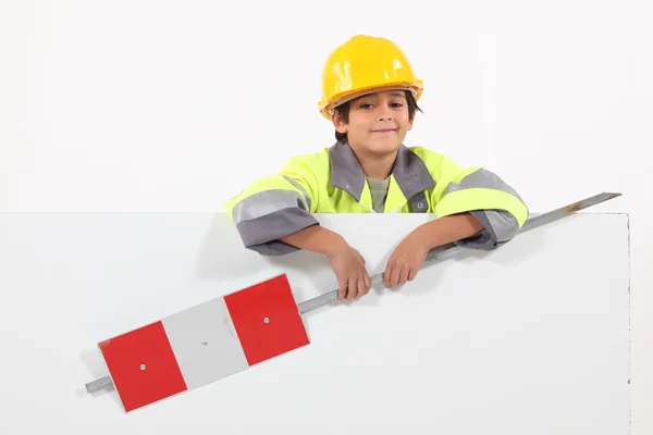 Little boy dressed as a road worker holding a traffic sign — Stock Photo, Image