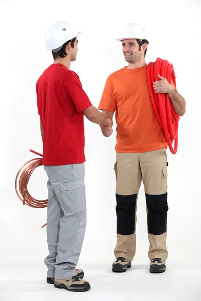 Plumbers shaking hands — Stock Photo, Image