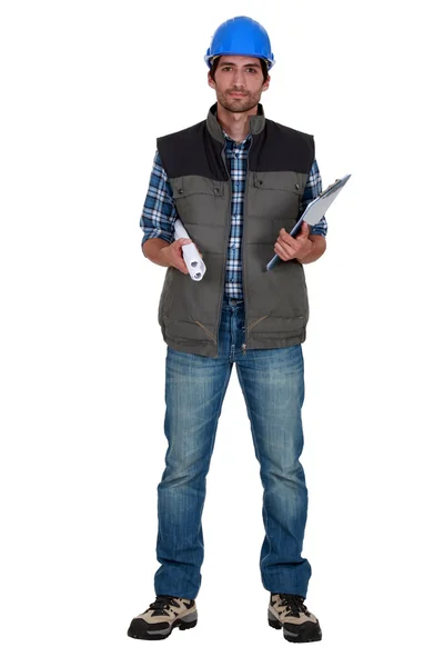 stock image Tradesman holding rolled-up blueprints and a clipboard