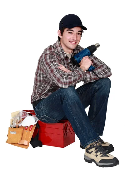 Young craftsman holding a drill — Stock Photo, Image