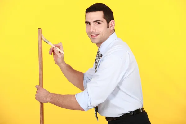 Office worker painting wood — Stock Photo, Image