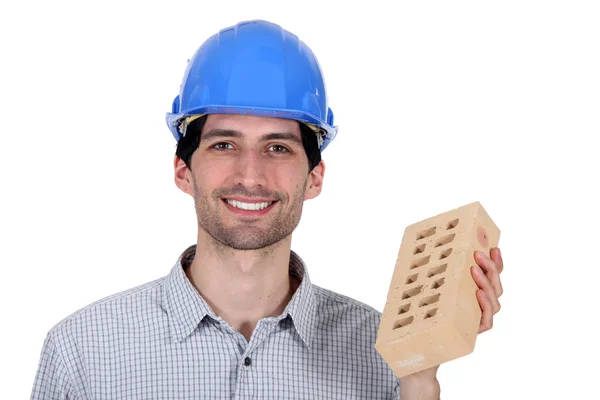 Builder showing a brick — Stock Photo, Image