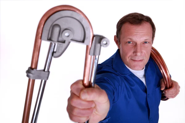Plumber bending copper piping — Stock Photo, Image