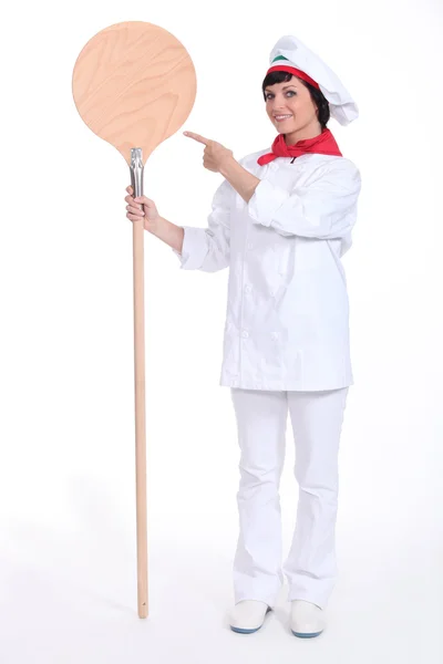 Female pizza chef with a wooden peel — Stock Photo, Image