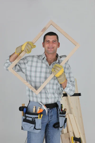 Woodworker holding a window frame — Stock Photo, Image