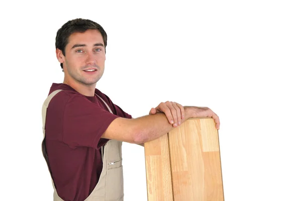 Carpenter holding planks of wood — Stock Photo, Image