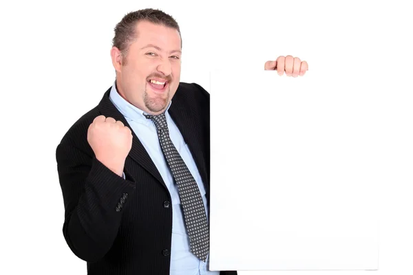 A successful businessman holding up a blank sign Stock Photo