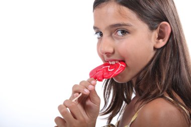 Young girl sucking on a lollipop clipart