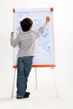 Child drawing on a flipchart clipart