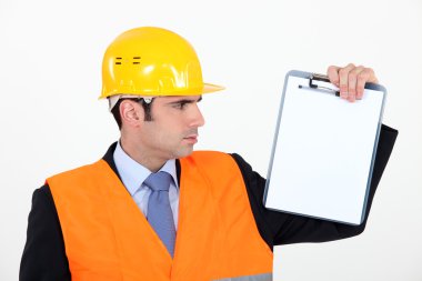 Engineer holding up a blank clipboard clipart