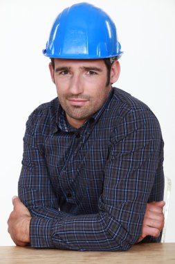 Portrait of an uneasy tradesman clipart
