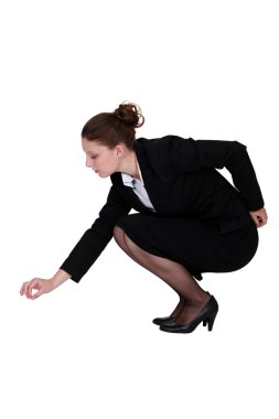 Businesswoman picking up a needle clipart