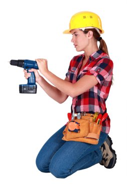 Woman with a cordless drill clipart