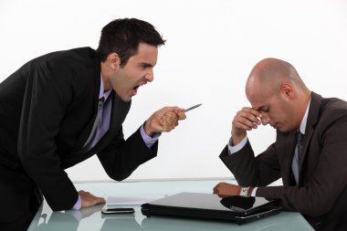 Businessman screaming at a colleague clipart