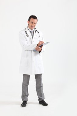 Doctor writing on clipboard smiling clipart