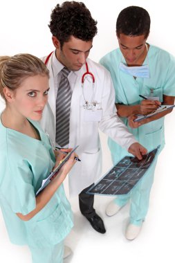 A team of medical professionals discussing the results of a patient's clipart