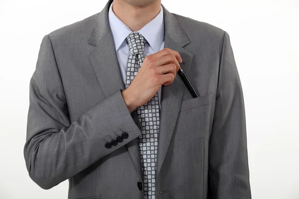 Businessman putting a pen in his pocket — Stock Photo, Image