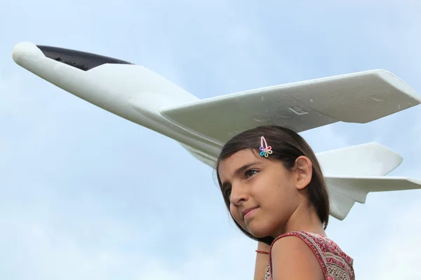 stock image Portrait of a girl holding model plane