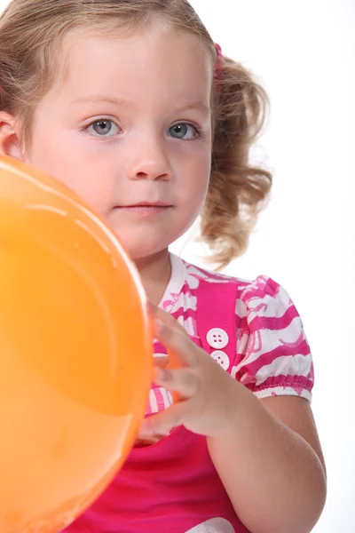 Little girl holding a balloon — Stock Photo, Image