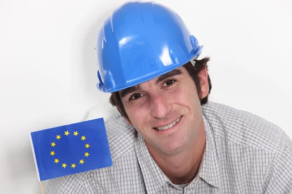 Smiling laborer with European flag — Stock Photo, Image
