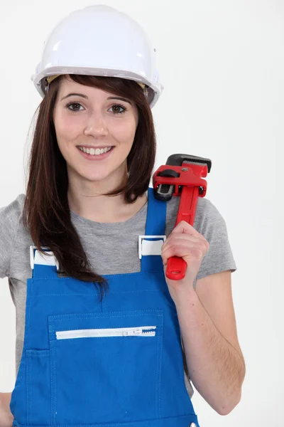 A female plumber holding a wrench. — Stock Photo, Image
