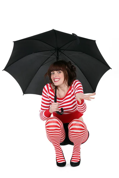 Woman with umbrella, studio shot — Stock Photo, Image