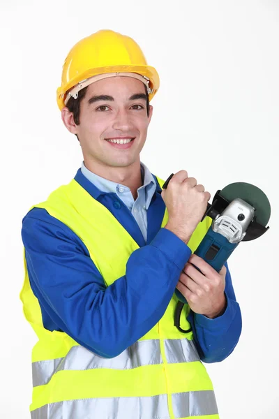 Tradesman in possesso di una smerigliatrice angolare — Foto Stock