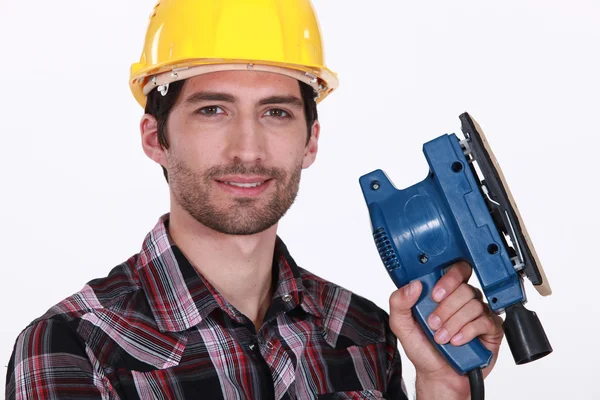 Werknemer met een schuurmachine — Stockfoto