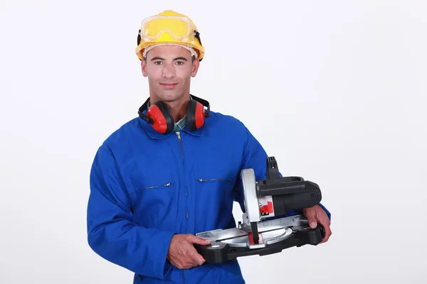 Tradesman holding a mitre saw — Stock Photo, Image
