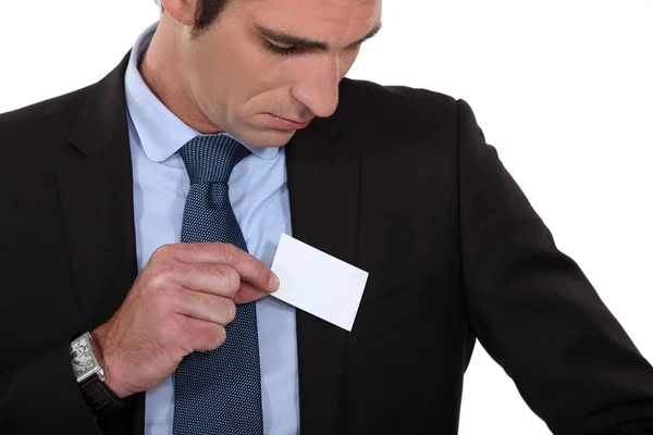 Man putting a business card into his pocket — Stock Photo, Image