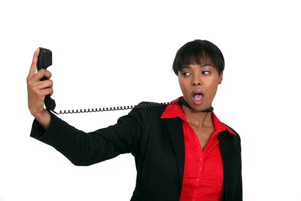 Afro-American businesswoman trying to hang herself with the phone cable — Stock Photo, Image