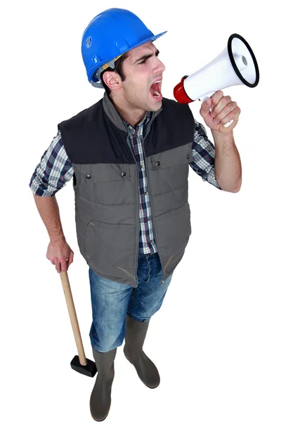 Construction worker with a loudspeaker — Stock Photo, Image
