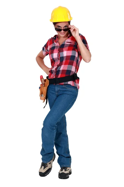 Sexy woman in craftsman overalls wearing sunglasses — Stock Photo, Image