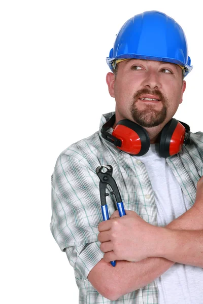 Tradesman holding a pair of pliers — Stock Photo, Image