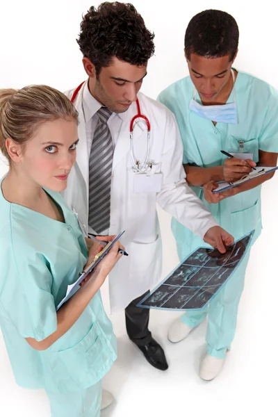 Un equipo de profesionales médicos discutiendo los resultados de un paciente — Foto de Stock