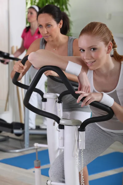 Mulheres jovens usando equipamentos de exercício — Fotografia de Stock