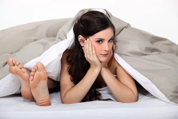 Women bored in bed Stock Picture