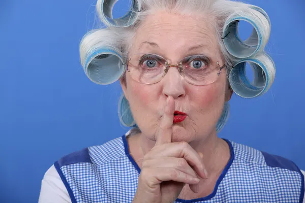 Old woman requesting to be quiet Stock Picture