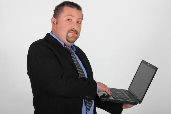 Businessman holding laptop Stock Photo