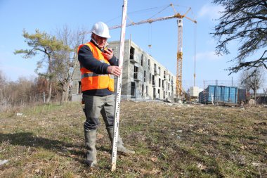 Surveyor on a construction site clipart