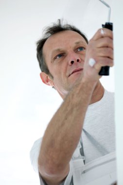 Tradesman painting a wall clipart