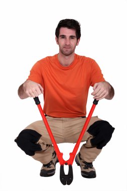 Man kneeling with bolt cutter clipart