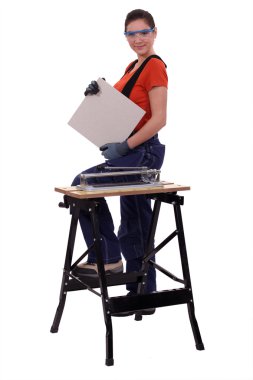 A handywoman showing a tile clipart