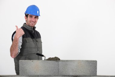 Thumbs up from a bricklayer clipart