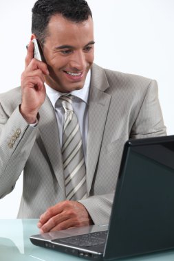 Businessman working at his desk clipart